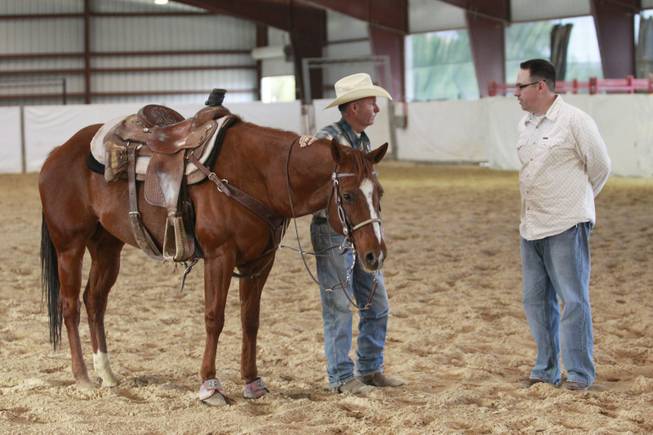 Las Vegas Sun sports editor Ray Brewer talks with UNLV rodeo coach Ric Griffith Nov. 2, 2012.